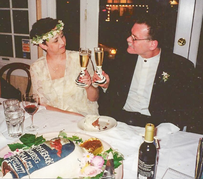 Toasting each other 5-23-99 with Pepe LePew and a wine bottle shaped cake.